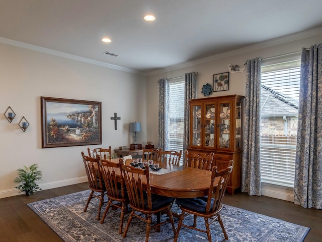 dining space featuring crown molding and dark hardwood / wood-style floors