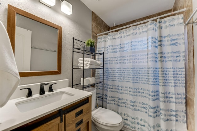 bathroom with a shower with shower curtain, vanity, and toilet