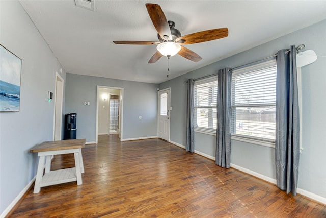 unfurnished living room with ceiling fan and dark hardwood / wood-style flooring