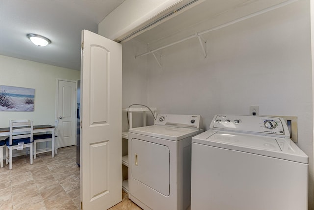 clothes washing area with washing machine and dryer