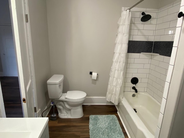 bathroom featuring wood-type flooring, shower / bath combo, and toilet