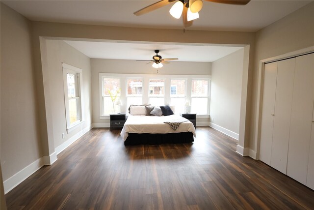 bedroom with dark hardwood / wood-style floors and ceiling fan