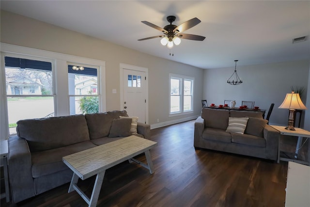 living room with ceiling fan and dark wood-type flooring