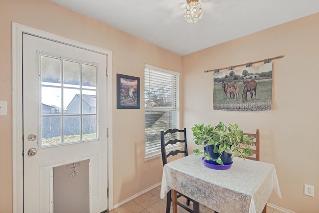 dining space featuring light tile patterned flooring and a healthy amount of sunlight