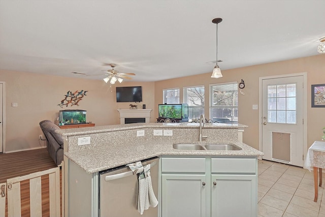 kitchen with dishwasher, sink, hanging light fixtures, ceiling fan, and light tile patterned flooring