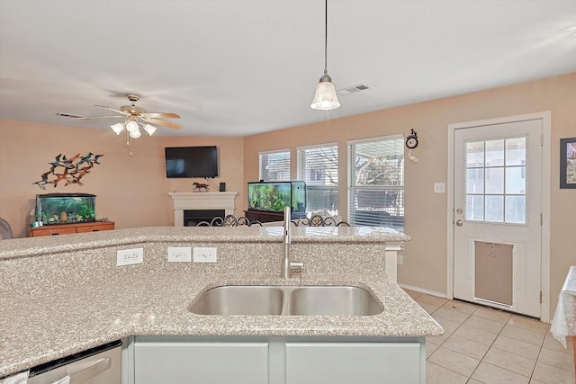 kitchen featuring stainless steel dishwasher, ceiling fan, sink, pendant lighting, and light tile patterned floors