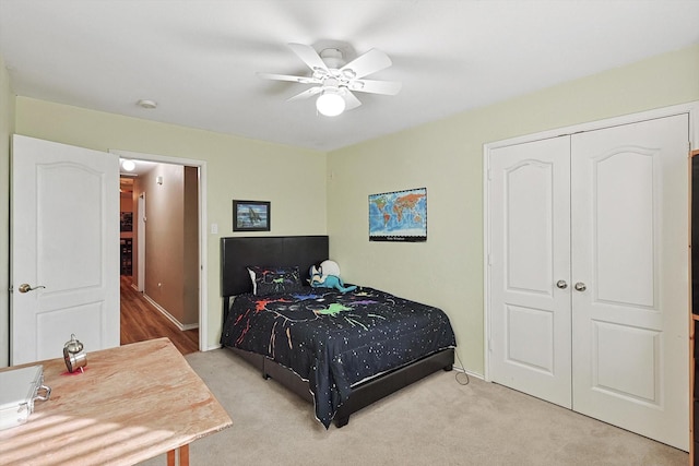 carpeted bedroom featuring a closet and ceiling fan