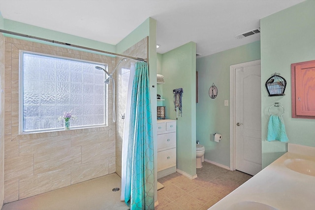 bathroom featuring vanity, curtained shower, and toilet