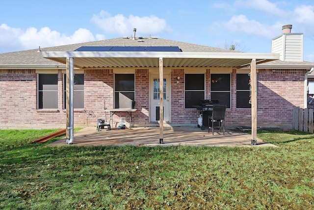 back of property featuring a yard and a patio