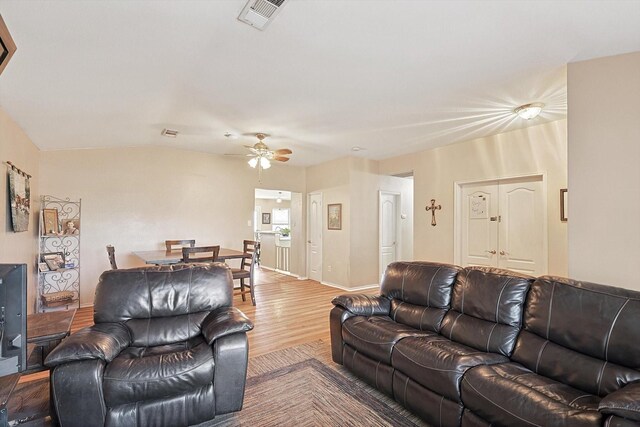 living room with hardwood / wood-style flooring and ceiling fan