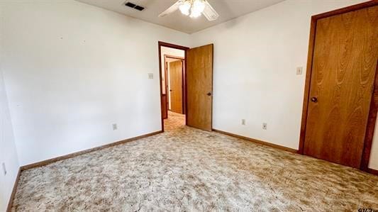 unfurnished bedroom with ceiling fan and light colored carpet