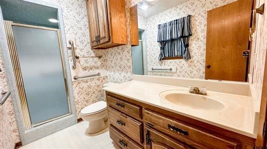 bathroom featuring vanity, toilet, and walk in shower