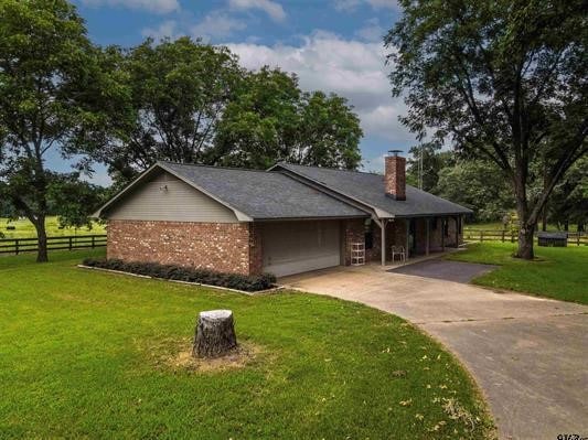 ranch-style house with a garage and a front yard