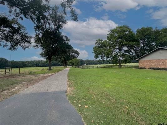 surrounding community featuring a lawn and a rural view