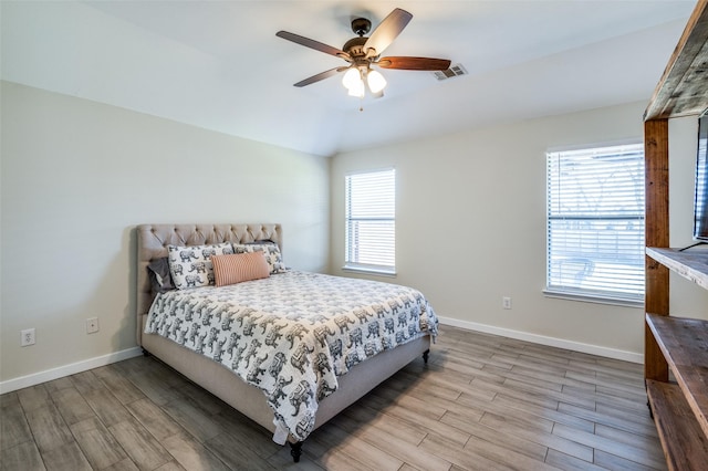 bedroom with ceiling fan and light hardwood / wood-style floors