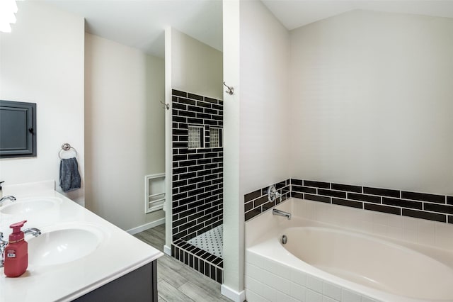 bathroom with plus walk in shower, vanity, and hardwood / wood-style flooring