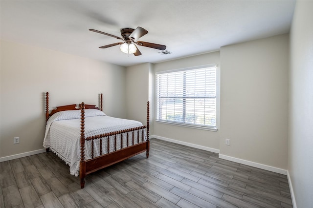 bedroom with ceiling fan and dark hardwood / wood-style flooring