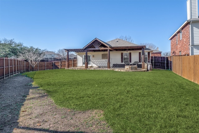 rear view of house featuring a yard, a pergola, and a patio