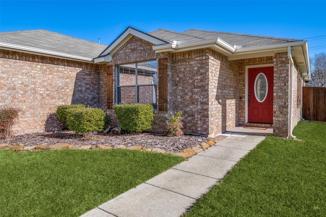 doorway to property featuring a lawn