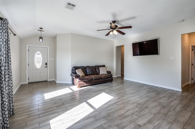 foyer with ceiling fan, lofted ceiling, and light hardwood / wood-style flooring