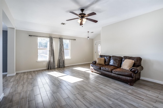 living room featuring ceiling fan and lofted ceiling