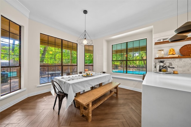 dining area with dark parquet floors and crown molding