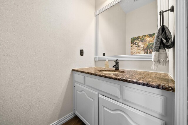 bathroom featuring hardwood / wood-style floors and vanity