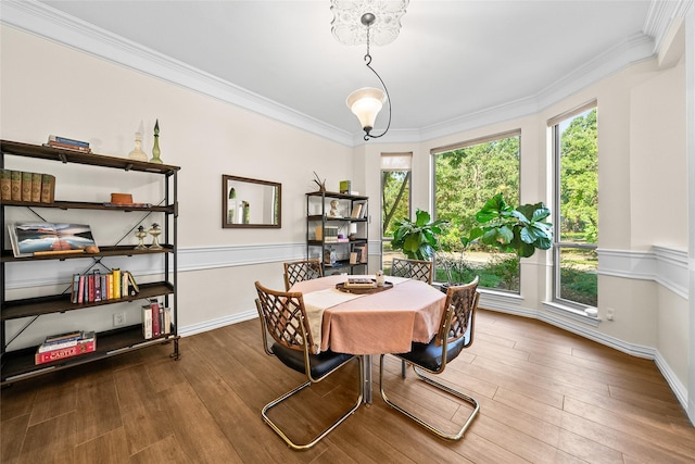 dining space with hardwood / wood-style floors and ornamental molding