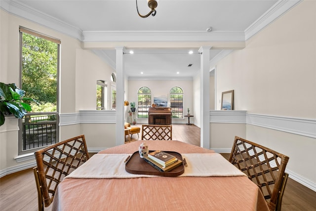 dining area with wood-type flooring and crown molding