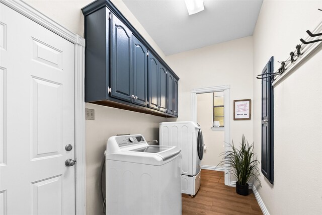 washroom with washer and clothes dryer and dark wood-type flooring