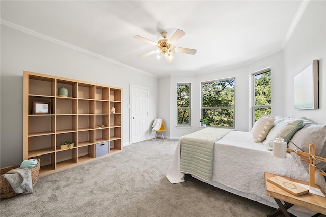 carpeted bedroom featuring ceiling fan and ornamental molding