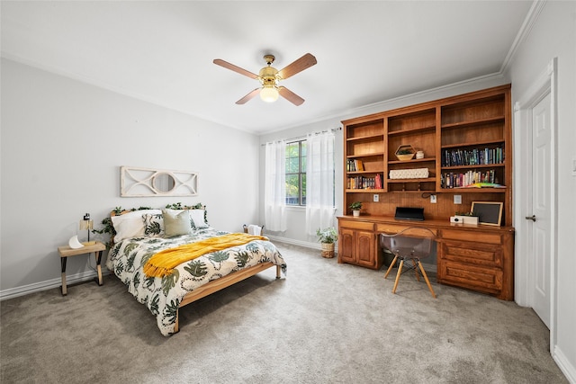 carpeted bedroom featuring ceiling fan and crown molding