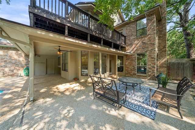 rear view of house featuring a patio, a balcony, and ceiling fan