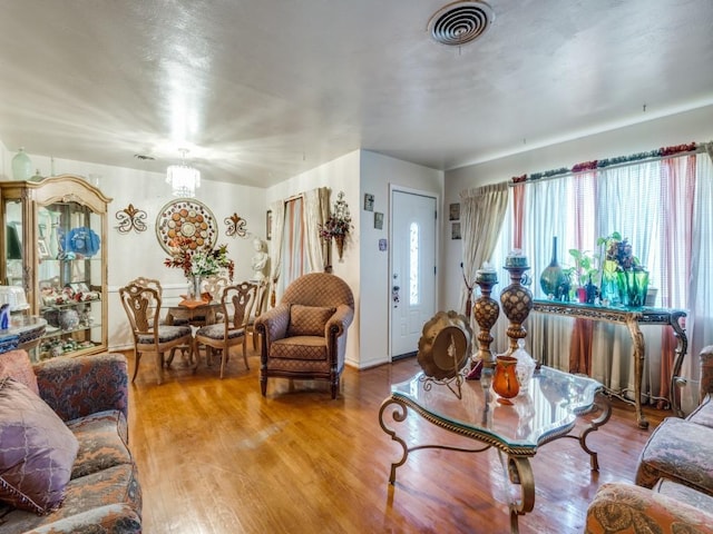 living room featuring a notable chandelier and hardwood / wood-style flooring