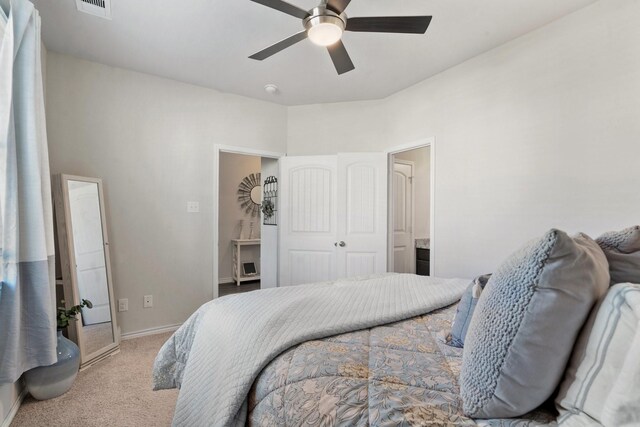 carpeted bedroom with ceiling fan and a closet