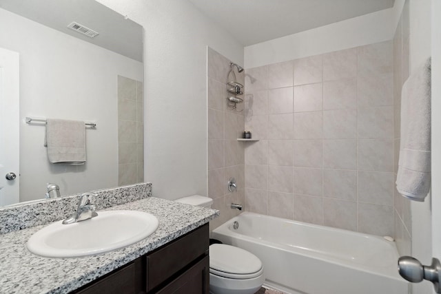 full bathroom featuring toilet, vanity, and tiled shower / bath