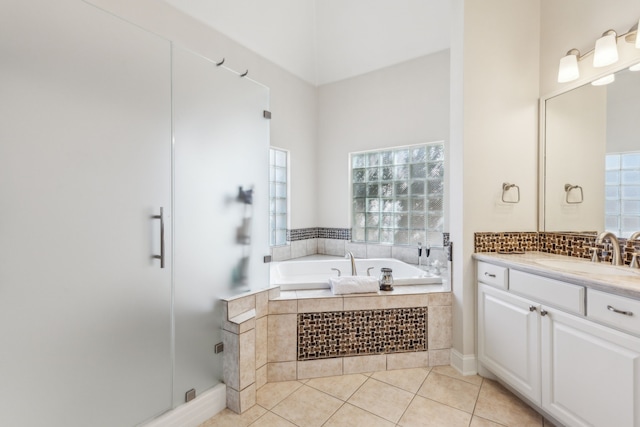 bathroom featuring a bath, tile patterned flooring, vanity, and a stall shower