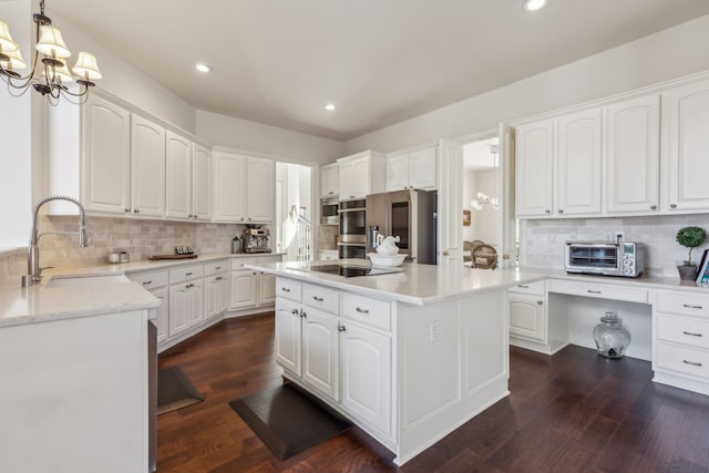 kitchen with a toaster, a sink, backsplash, and a kitchen island