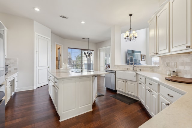 kitchen with a sink, a notable chandelier, tasteful backsplash, a center island, and dishwasher