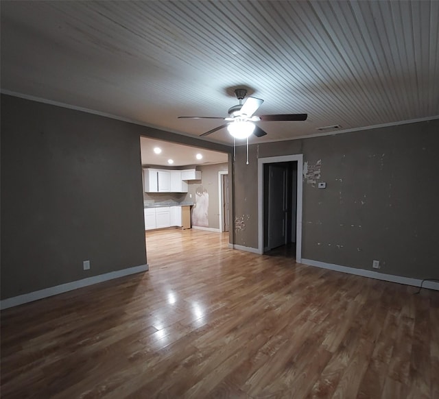 unfurnished living room with ceiling fan, hardwood / wood-style floors, and ornamental molding