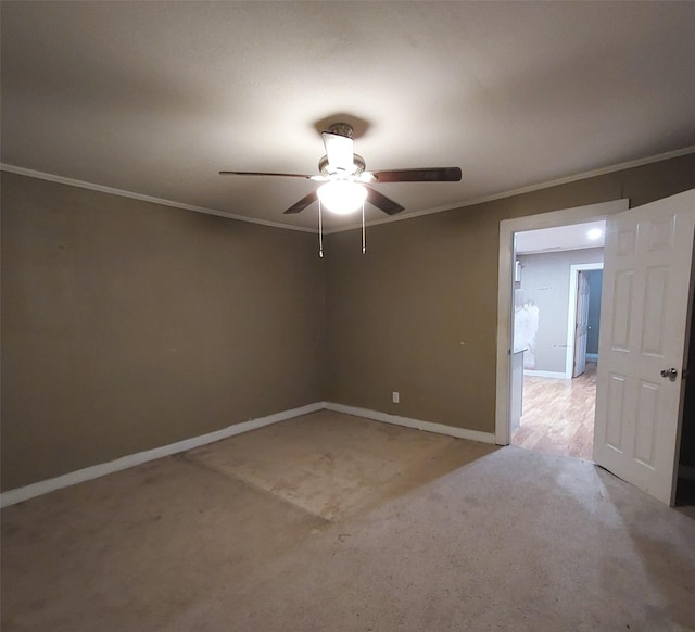 carpeted empty room with crown molding and ceiling fan