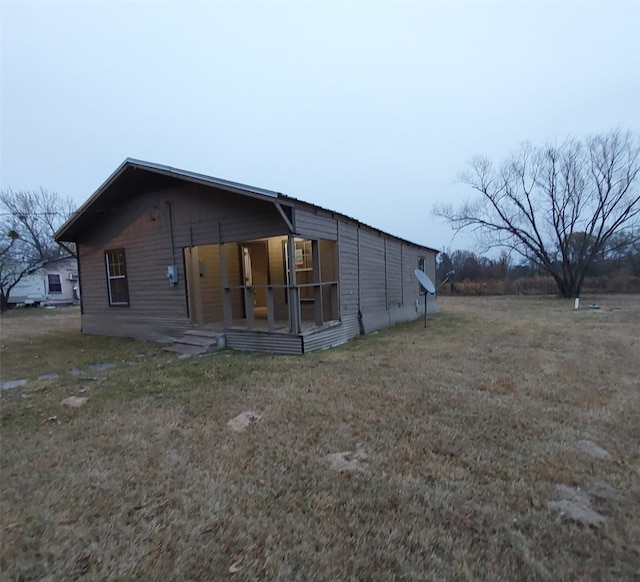 rear view of house featuring a yard