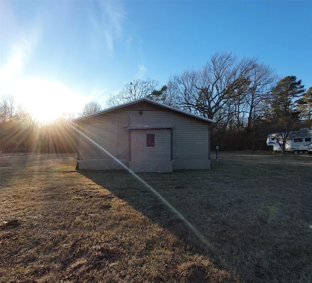 outdoor structure at dusk featuring a yard