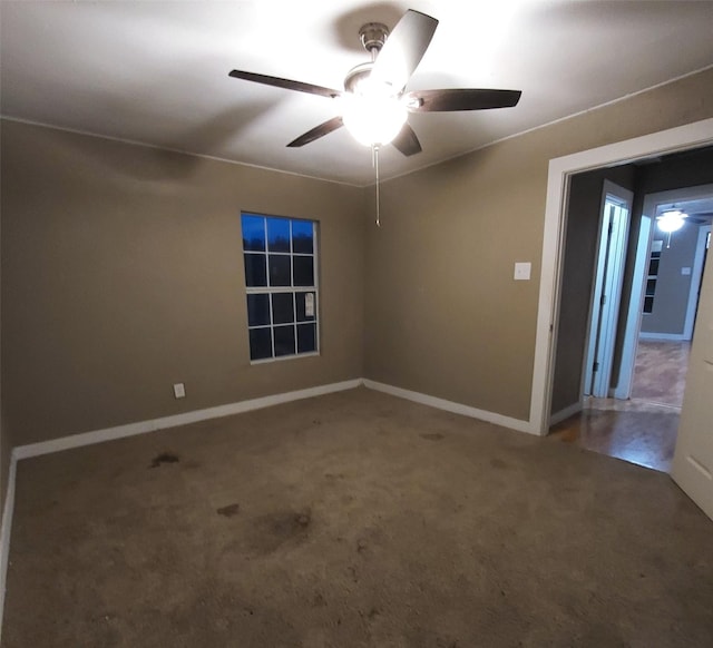 carpeted empty room featuring ceiling fan