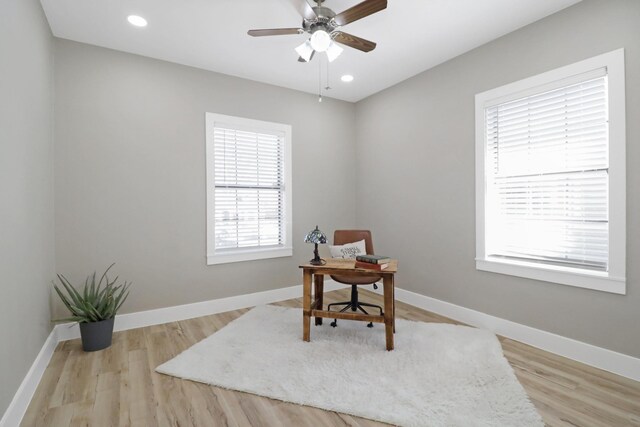 bedroom with multiple windows, ceiling fan, and light hardwood / wood-style flooring