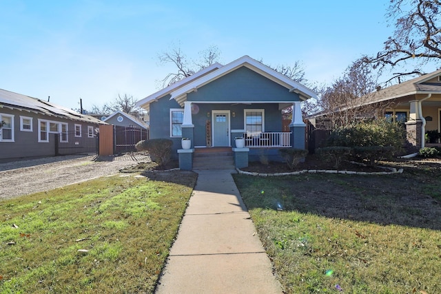 bungalow-style home with covered porch and a front lawn