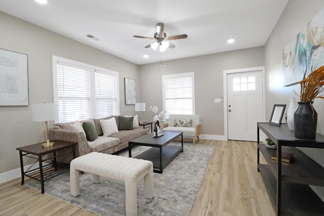 living room with ceiling fan and light wood-type flooring