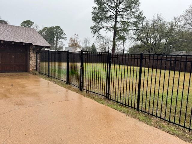 view of gate with a yard