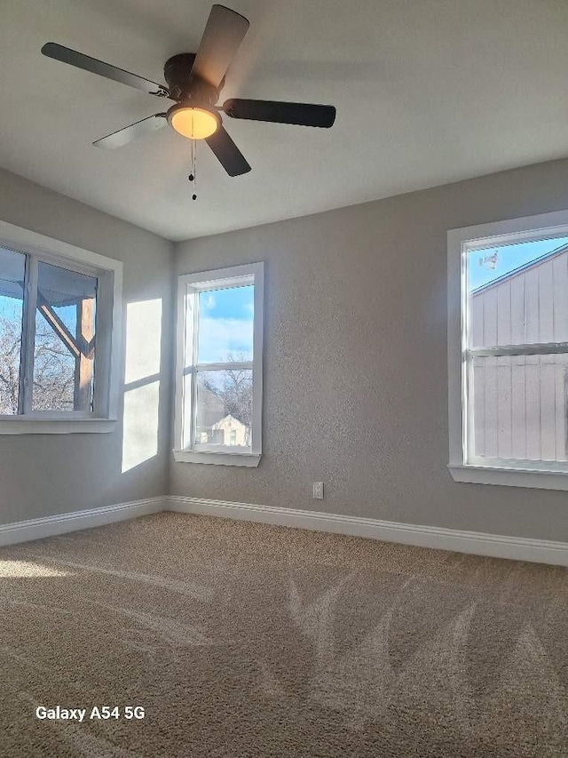 carpeted empty room with ceiling fan