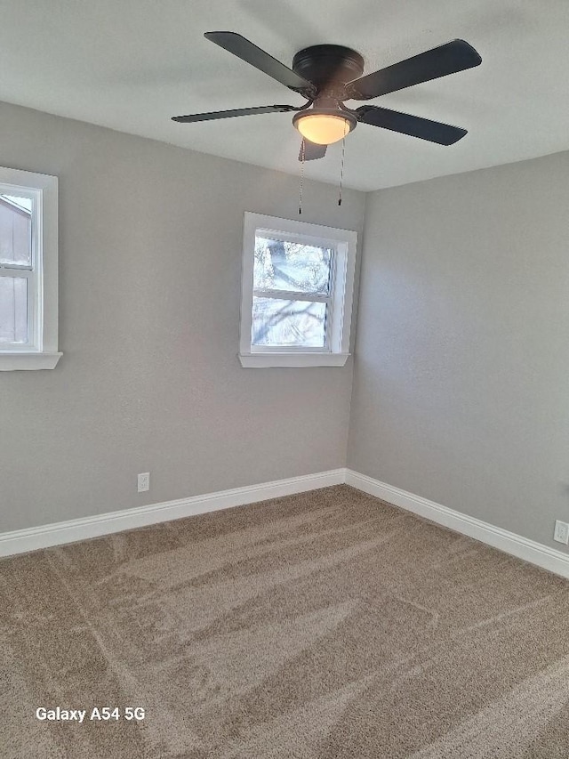 unfurnished room featuring carpet flooring, ceiling fan, and plenty of natural light